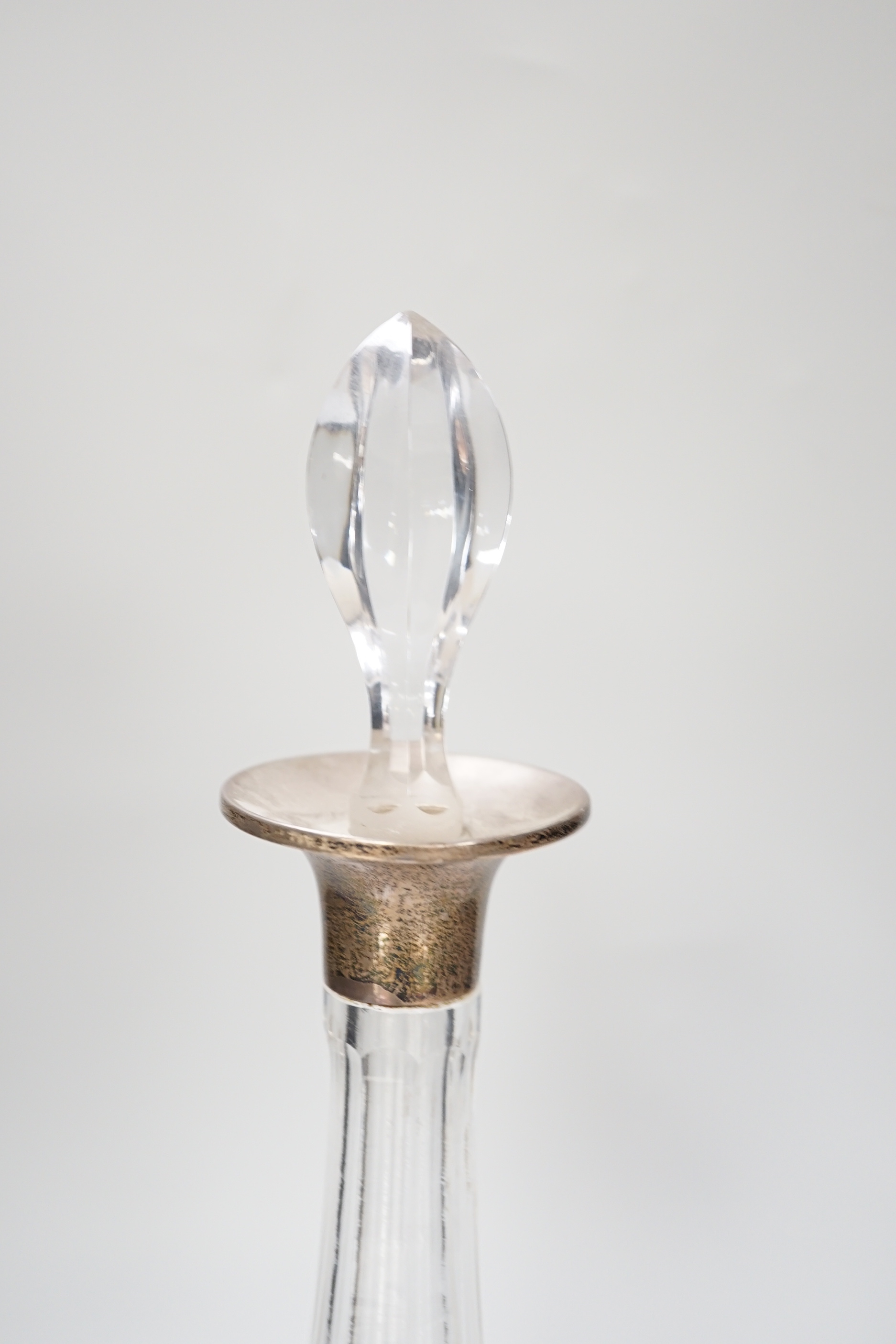 A George V silver collared cut glass decanter and stopper, London 1926, 37cm tall